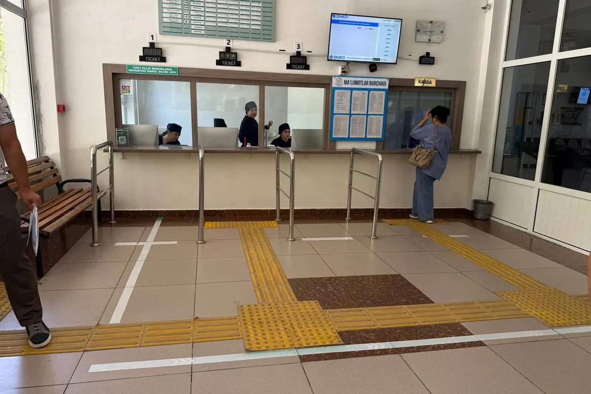Interior · Reception windows — tactile tiles guide the patient to the right counter.