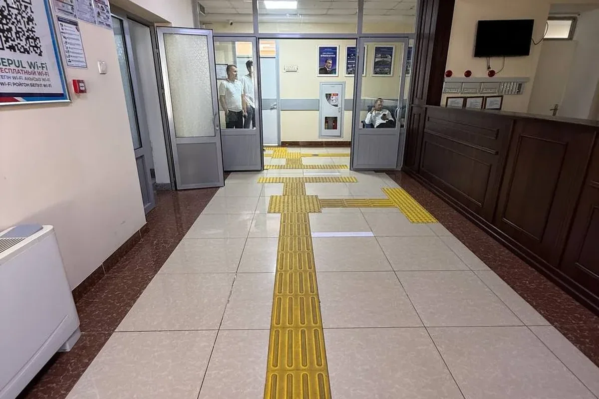 Interior · Yellow tactile guiding tiles in the corridor — lead the visually impaired to the reception and departments underfoot.