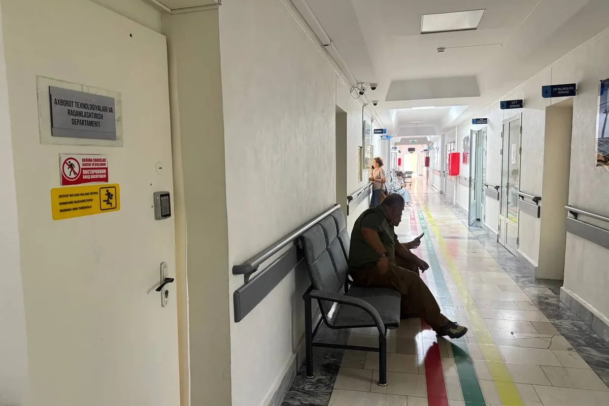 Interior · Patient corridor — coloured floor lines guide the way, the wall handrail is for support.